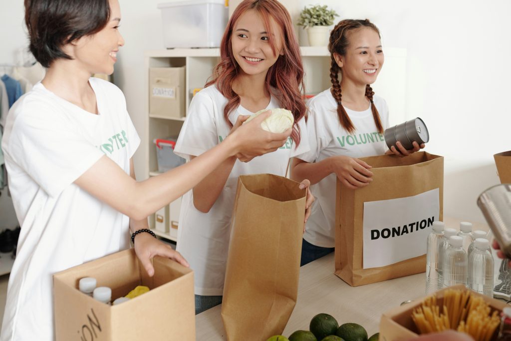 three young women working with donations. Seeking God's Kingdom First: A Practical Guide for Today